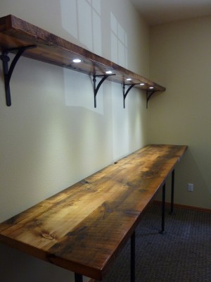 Standing Desk with shelf and recessed LED puck lights on a dimmer switch; Reclaimed barn wood, black gas pips, LED puck lights; 108" x 23" x 30 1/4"; 2015; Meg Thompson